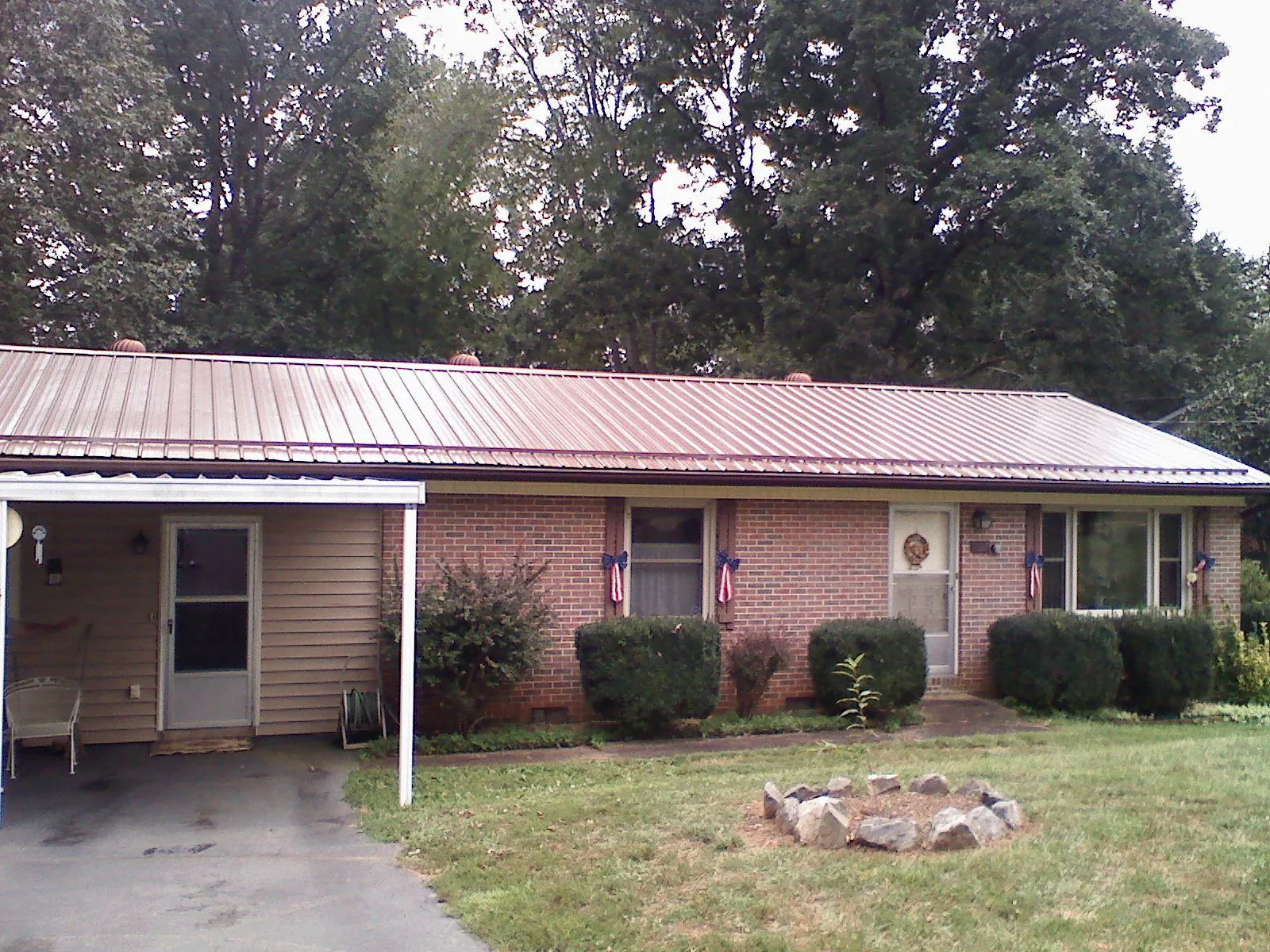 Bronze metal roof and carport on a brick ranch home — Roof Repair work by our crew in Happy Valley